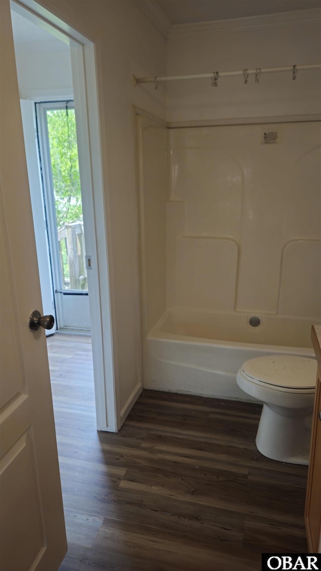 full bathroom with toilet, crown molding, wood finished floors, and  shower combination