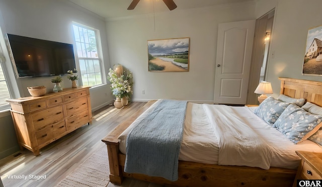 bedroom with light wood-style flooring, baseboards, a ceiling fan, and crown molding