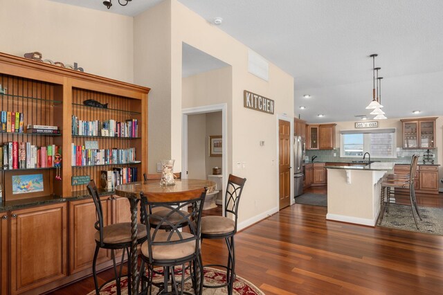 dining area featuring dark wood-style floors, recessed lighting, and baseboards