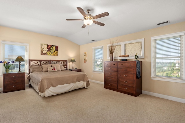 bedroom featuring vaulted ceiling, baseboards, visible vents, and light colored carpet