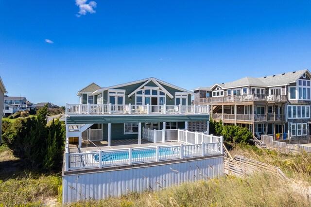 rear view of house featuring an outdoor pool