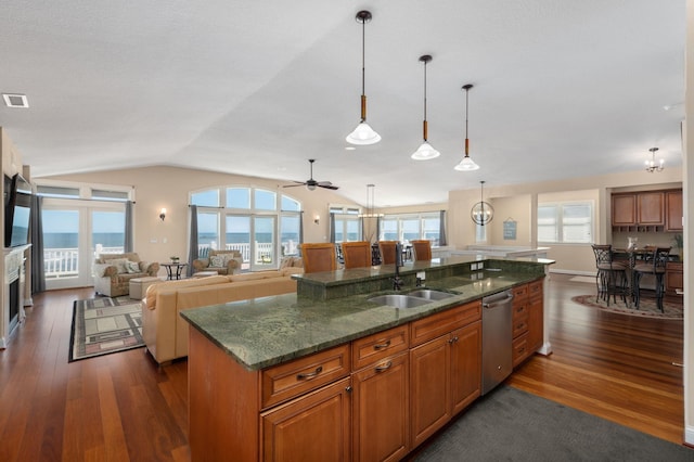 kitchen with lofted ceiling, dark wood-type flooring, brown cabinetry, and a sink