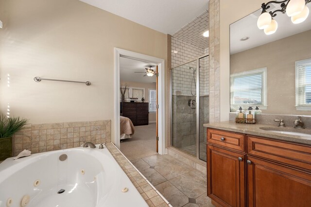 bathroom with a stall shower, connected bathroom, vanity, tile patterned flooring, and a jetted tub