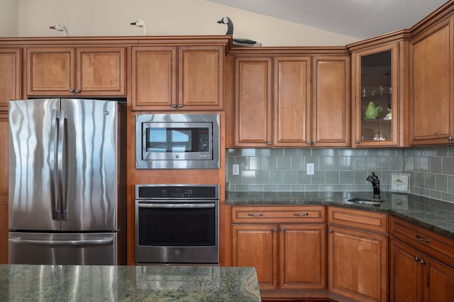151 Buffell Head Rd Lot 179, Duck, NC 27949 - kitchen featuring appliances with stainless steel finishes, brown cabinetry, a sink, and vaulted ceiling