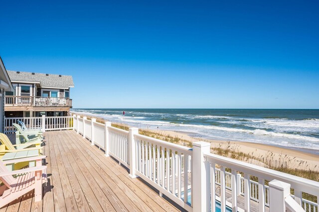 exterior space featuring a water view and a view of the beach