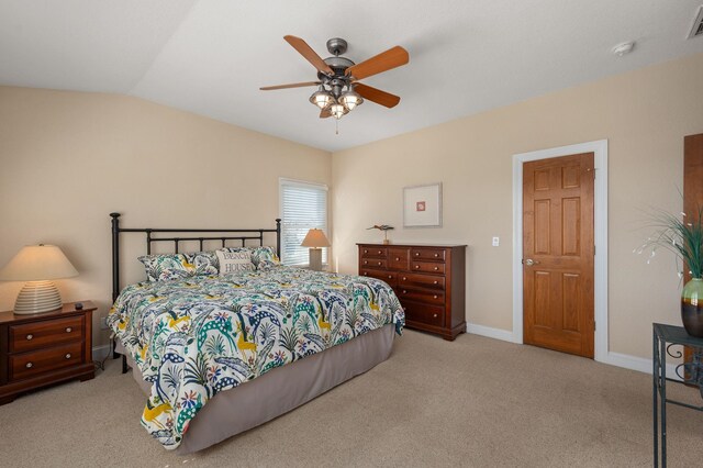 carpeted bedroom with a ceiling fan, visible vents, vaulted ceiling, and baseboards