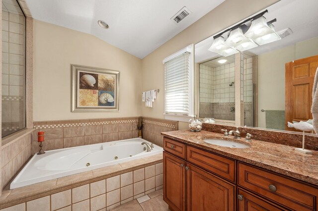 full bath with lofted ceiling, visible vents, a shower stall, vanity, and a whirlpool tub