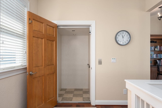 interior space with baseboards and tile patterned floors