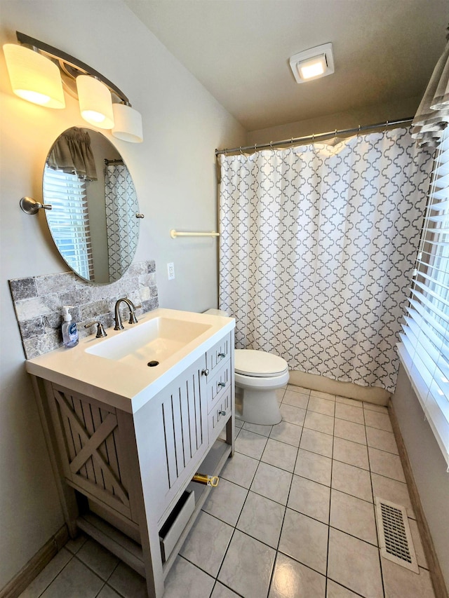 bathroom with toilet, vanity, visible vents, and tile patterned floors