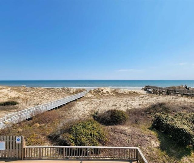 view of water feature with fence and a view of the beach