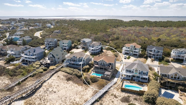 drone / aerial view with a water view and a residential view