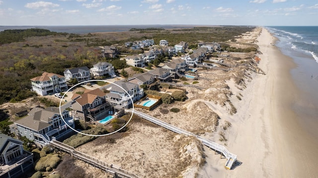 aerial view with a water view, a residential view, and a view of the beach