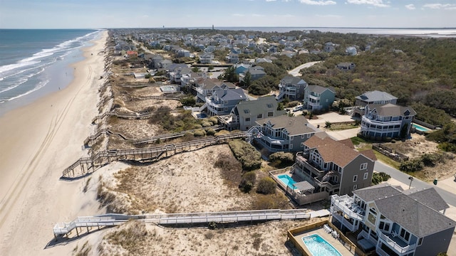 aerial view featuring a water view and a beach view