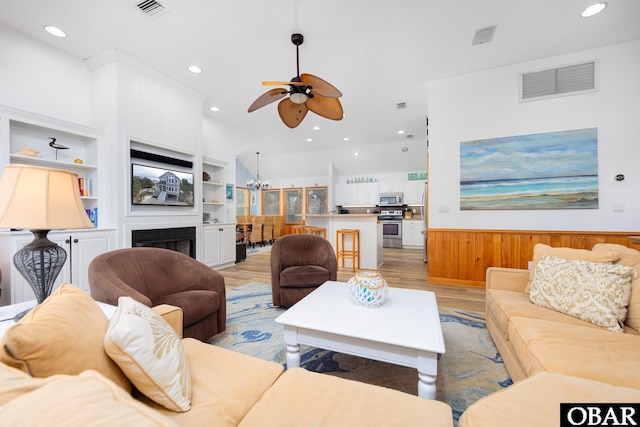 living room with recessed lighting, visible vents, and light wood finished floors