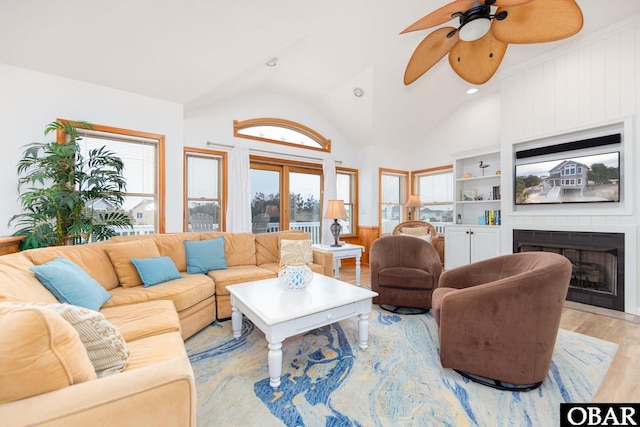 living area with recessed lighting, a fireplace, a ceiling fan, vaulted ceiling, and light wood-type flooring