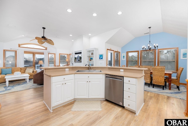 kitchen featuring a center island with sink, open floor plan, stainless steel dishwasher, and light countertops