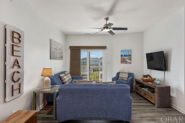 living room with ceiling fan and dark wood-type flooring