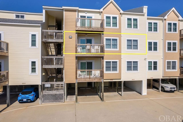 view of building exterior featuring covered parking