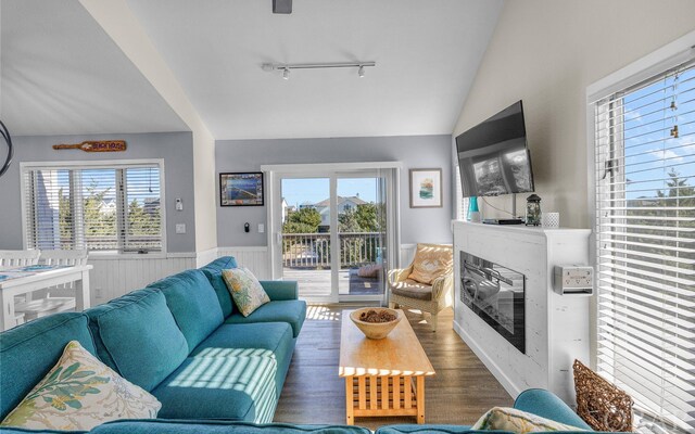 25056 Sea Vista Ct Lot 29, Waves, NC 27982 - living area with plenty of natural light, a glass covered fireplace, wainscoting, and vaulted ceiling