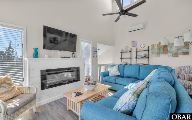 25056 Sea Vista Ct Lot 29, Waves, NC 27982 - living area featuring a wall mounted air conditioner, wood finished floors, and a healthy amount of sunlight