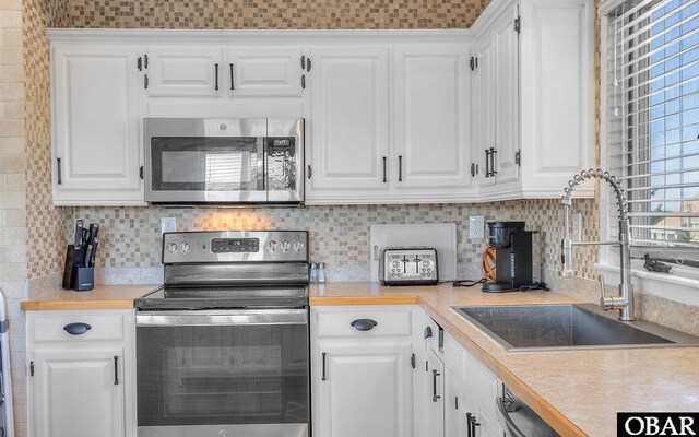 25056 Sea Vista Ct Lot 29, Waves, NC 27982 - kitchen with appliances with stainless steel finishes, white cabinets, and light countertops