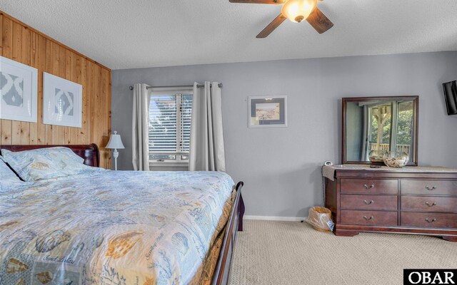25056 Sea Vista Ct Lot 29, Waves, NC 27982 - bedroom featuring light carpet, wood walls, and a textured ceiling