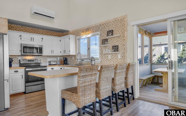 25056 Sea Vista Ct Lot 29, Waves, NC 27982 - kitchen with stainless steel appliances, a peninsula, a kitchen bar, and light countertops