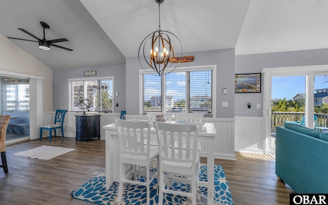 dining area featuring a healthy amount of sunlight, a wainscoted wall, dark wood-style flooring, and lofted ceiling