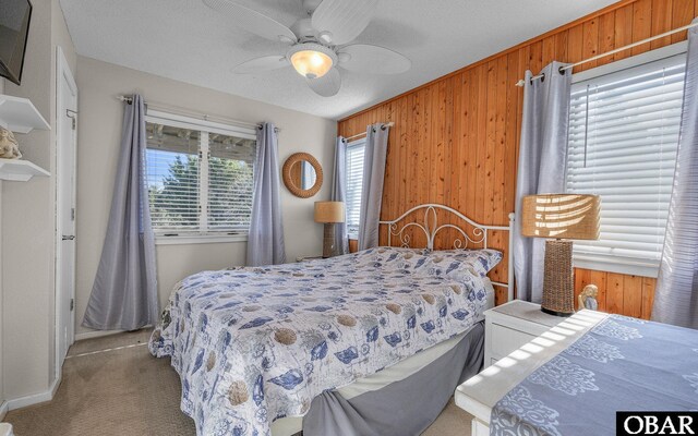 25056 Sea Vista Ct Lot 29, Waves, NC 27982 - bedroom featuring ceiling fan, wood walls, and light colored carpet