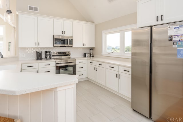 kitchen with pendant lighting, light countertops, visible vents, appliances with stainless steel finishes, and white cabinets