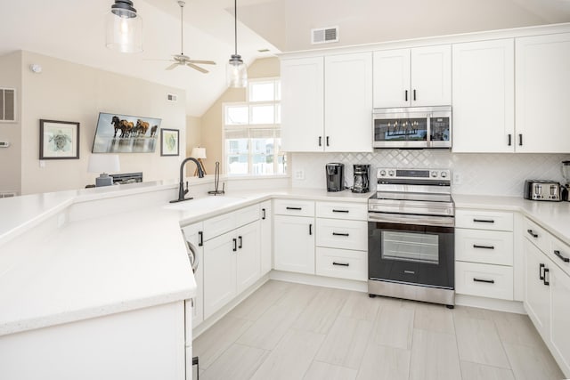 1229 Ocean Hill Ct Lot 120, Corolla, NC 27927 - kitchen featuring appliances with stainless steel finishes, a sink, ceiling fan, a peninsula, and tasteful backsplash