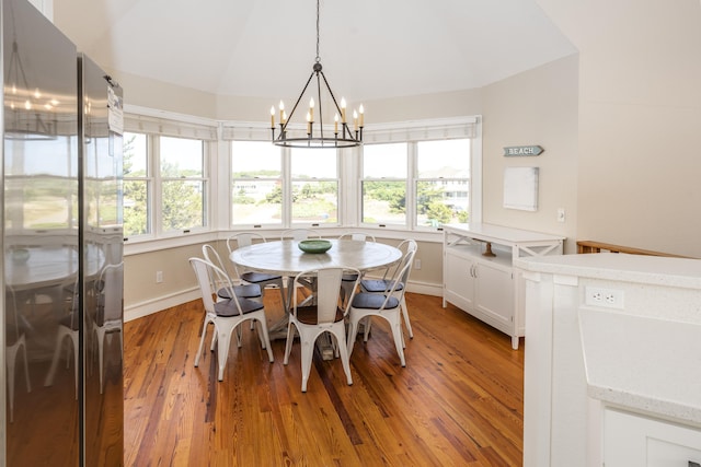 1229 Ocean Hill Ct Lot 120, Corolla, NC 27927 - dining area with a chandelier, lofted ceiling, healthy amount of natural light, light wood finished floors, and baseboards