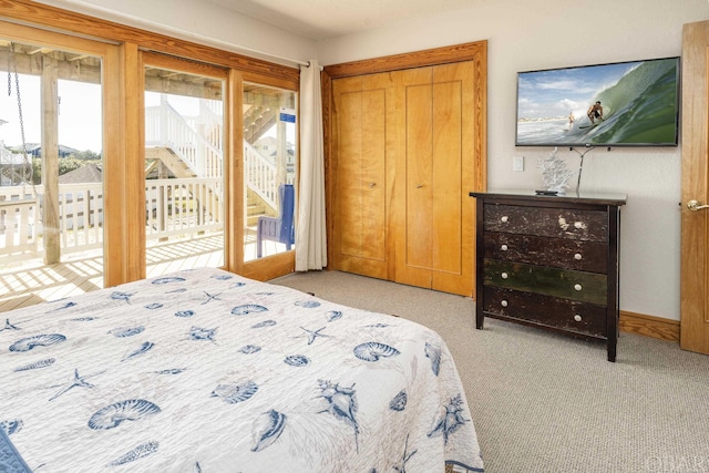 bedroom with access to exterior and light colored carpet