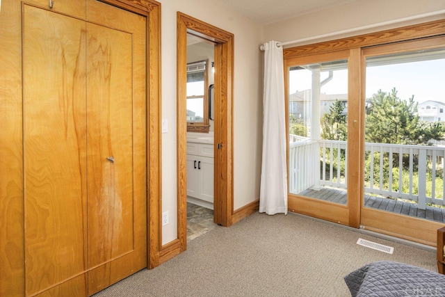 interior space featuring light carpet, visible vents, and baseboards