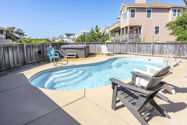 view of pool featuring a patio area, a hot tub, a fenced in pool, and a fenced backyard