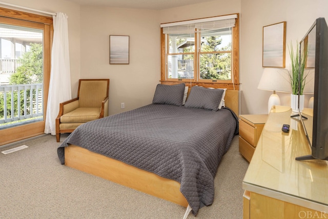 bedroom with visible vents and carpet flooring