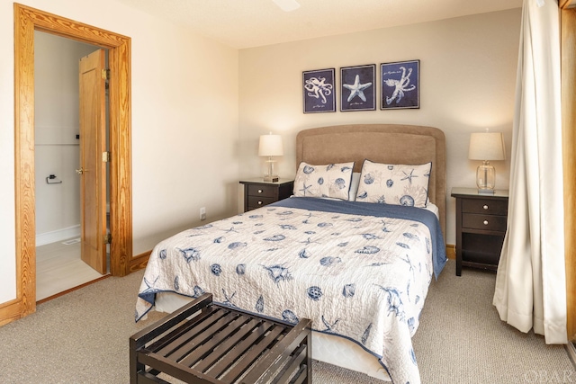 bedroom featuring light colored carpet and baseboards