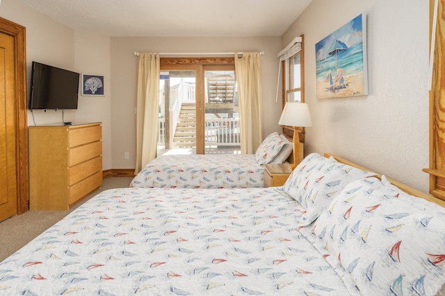 bedroom featuring access to outside and carpet flooring