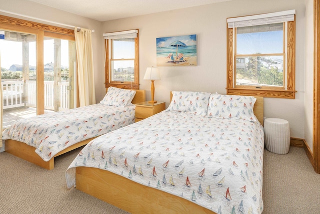 1229 Ocean Hill Ct Lot 120, Corolla, NC 27927 - bedroom featuring access to exterior, carpet flooring, and baseboards