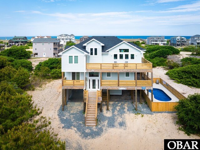 2267 Sandpiper Rd Lot 29, Corolla, NC 27927 - back of property with a carport, stairs, driveway, a balcony, and a deck