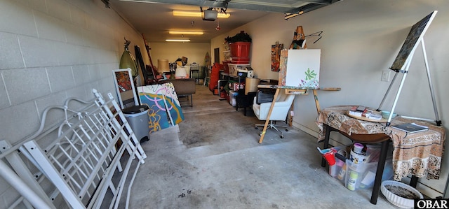 garage with concrete block wall and a garage door opener