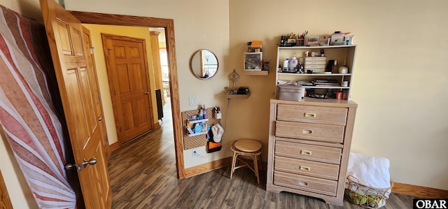 interior space featuring dark wood finished floors and baseboards