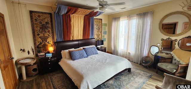 bedroom featuring visible vents, ceiling fan, and wood finished floors