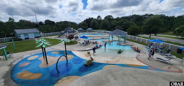 view of home's community featuring playground community, a yard, a patio area, and fence