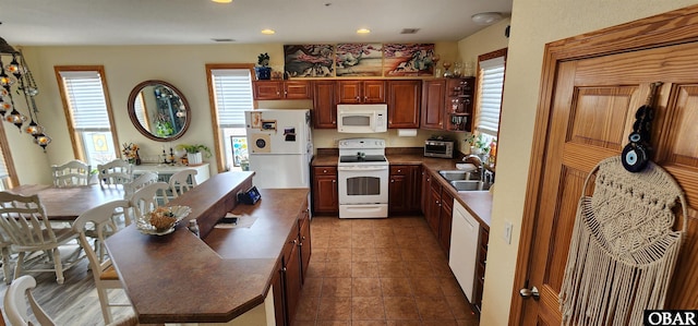 kitchen featuring white appliances, dark tile patterned flooring, open shelves, a sink, and recessed lighting