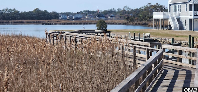 dock area featuring stairs and a water view