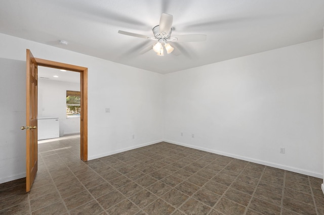 empty room featuring baseboards and a ceiling fan