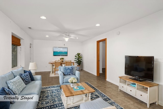 living area featuring dark tile patterned floors, baseboards, a ceiling fan, and recessed lighting