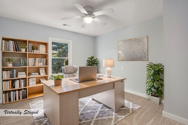 home office with light carpet, baseboards, visible vents, and a ceiling fan