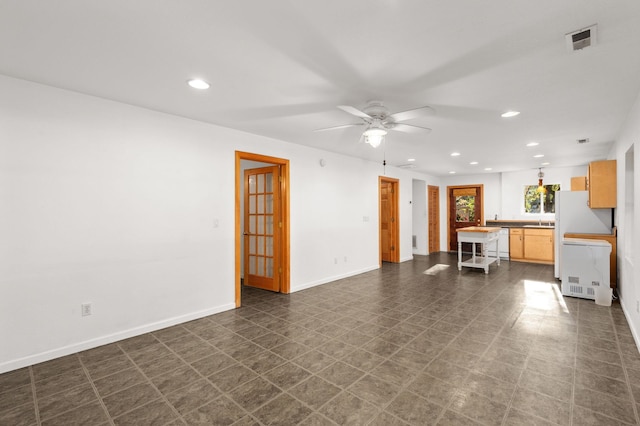 unfurnished living room featuring baseboards, visible vents, ceiling fan, dark floors, and recessed lighting